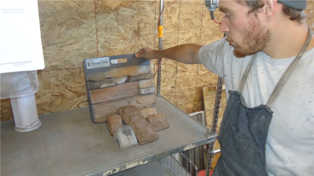 Worker checking a part at a workstation